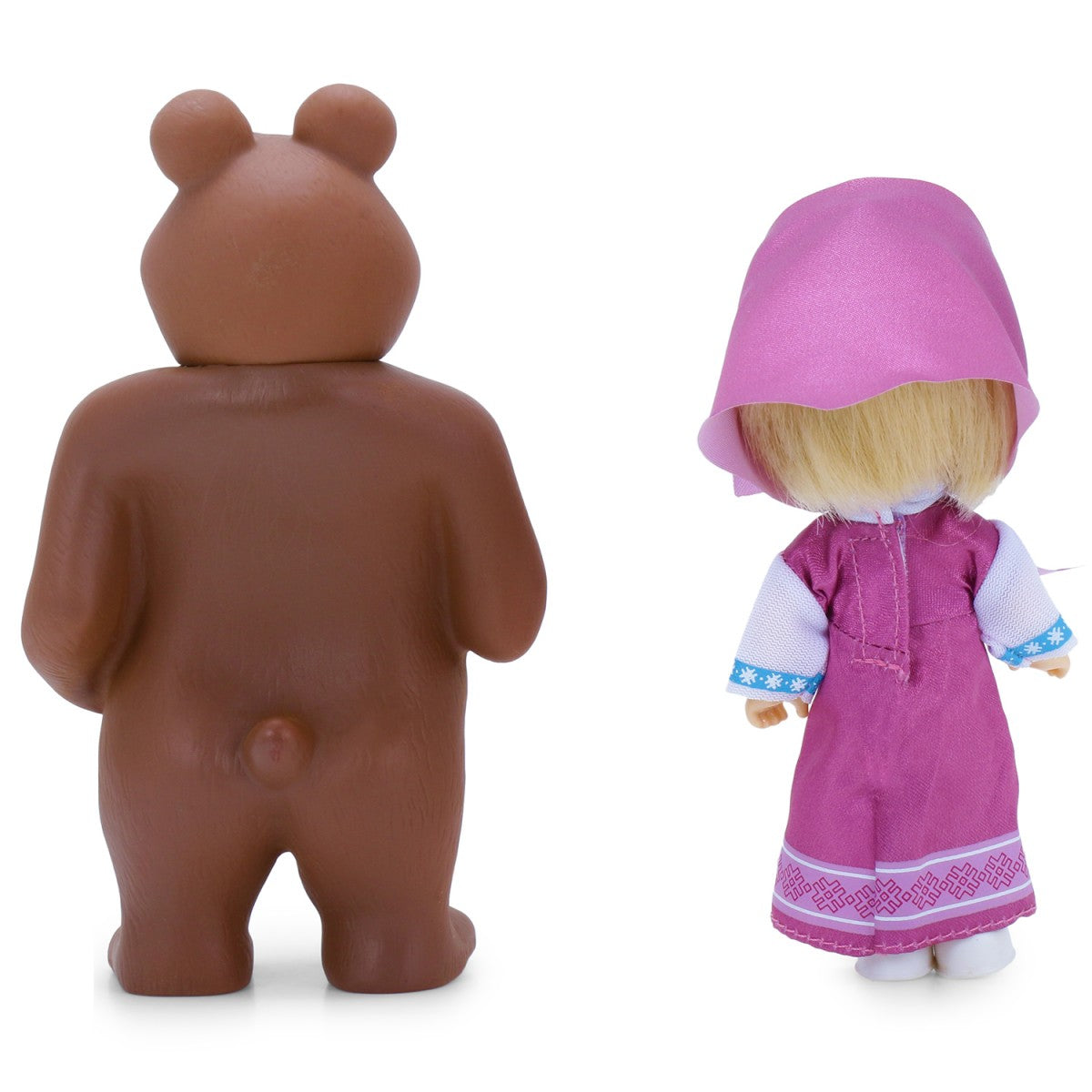 Brown bear figurine and a doll in a pink dress with a hood on a white background