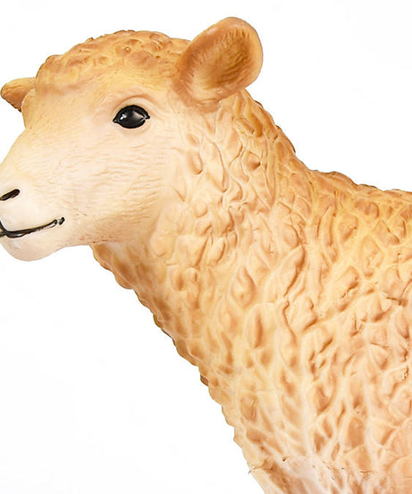 Close-up of a beige sheep figurine on a white background